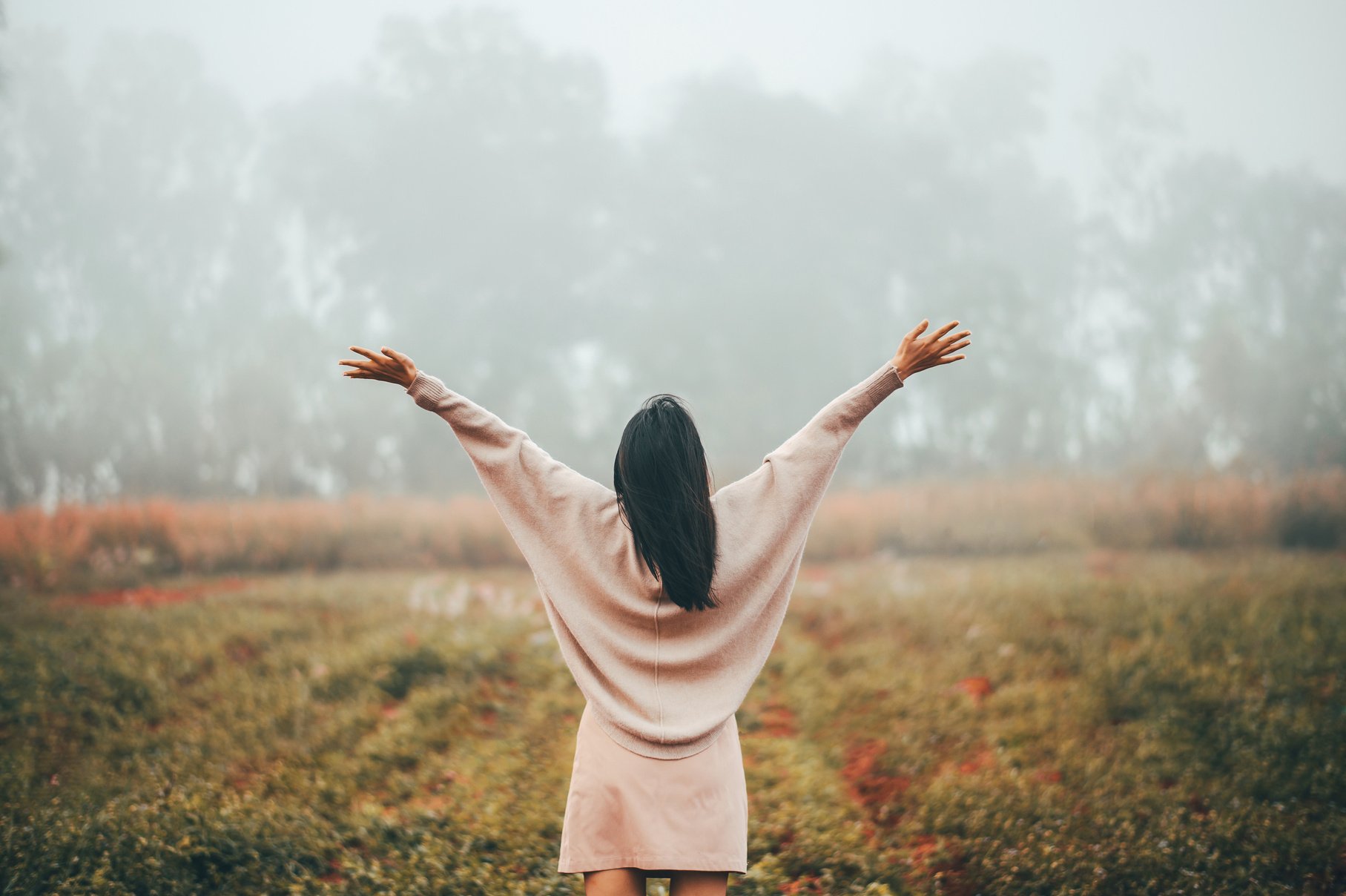 Woman with Open Arms Standing Outdoors