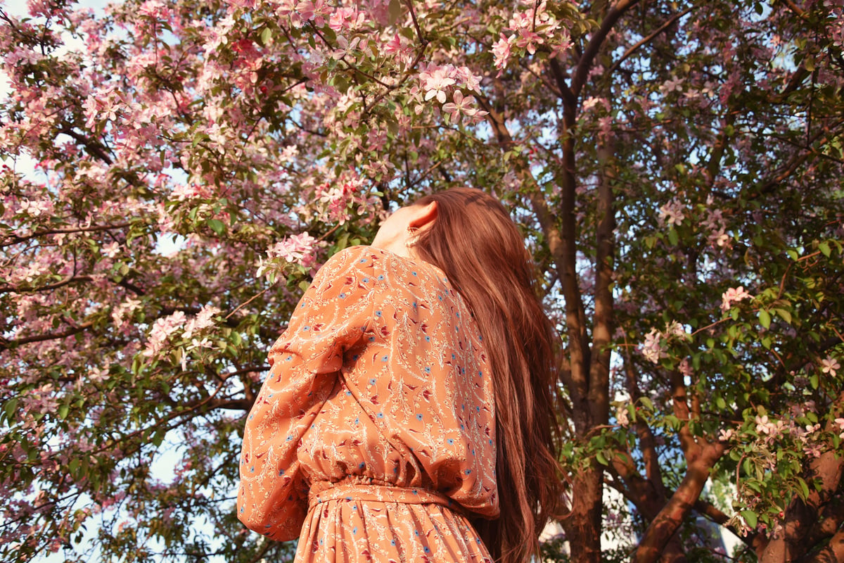 Faceless Woman in Blooming Garden in Park